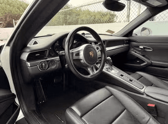Porsche 911 Carrera S Coupe — driver cockpit with open door