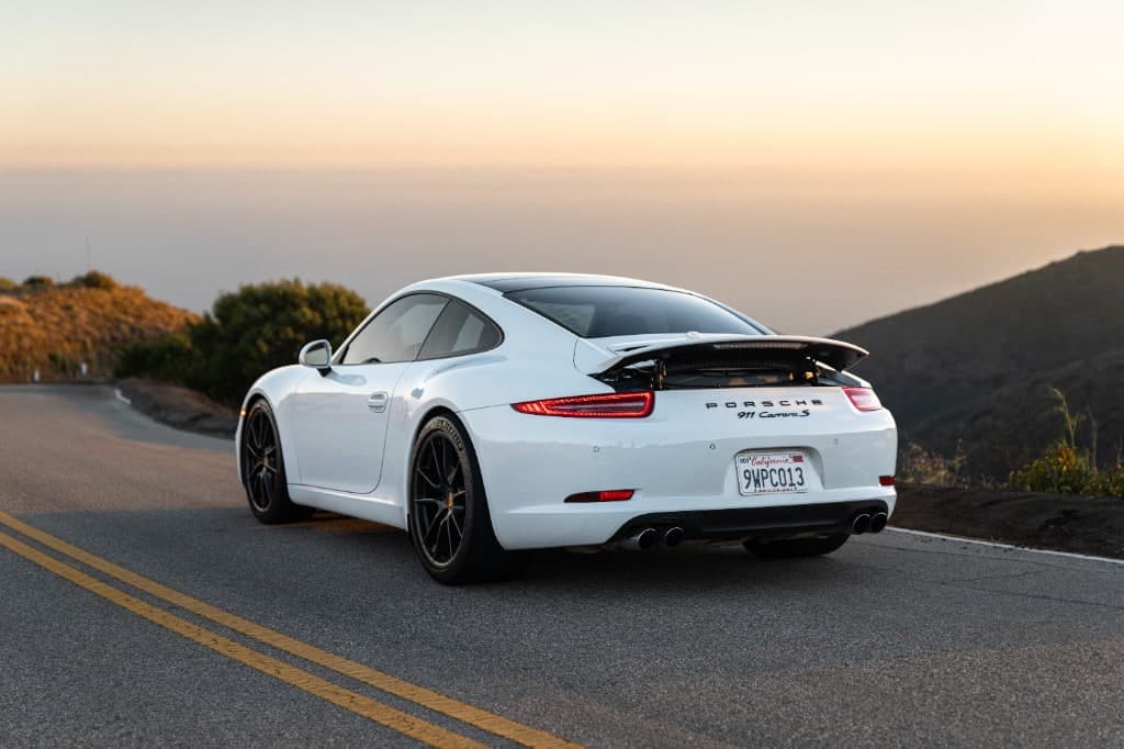 2015 Porsche 911 Carrera S Coupe — rear three-quarter at golden hour