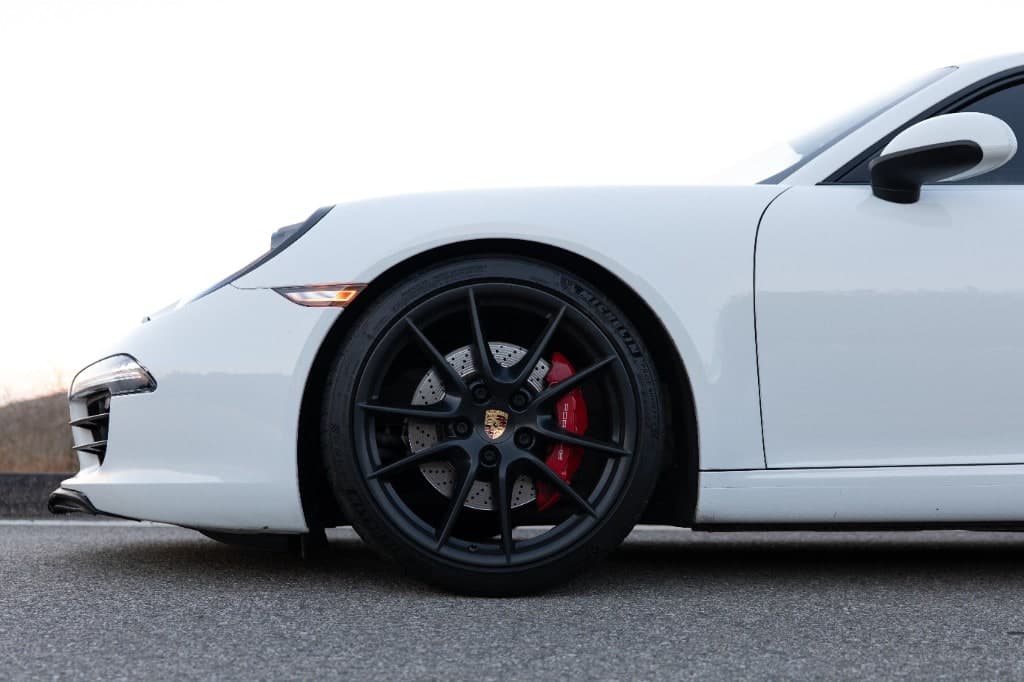 2015 Porsche 911 Carrera S Coupe — wheel and red Porsche brake caliper detail