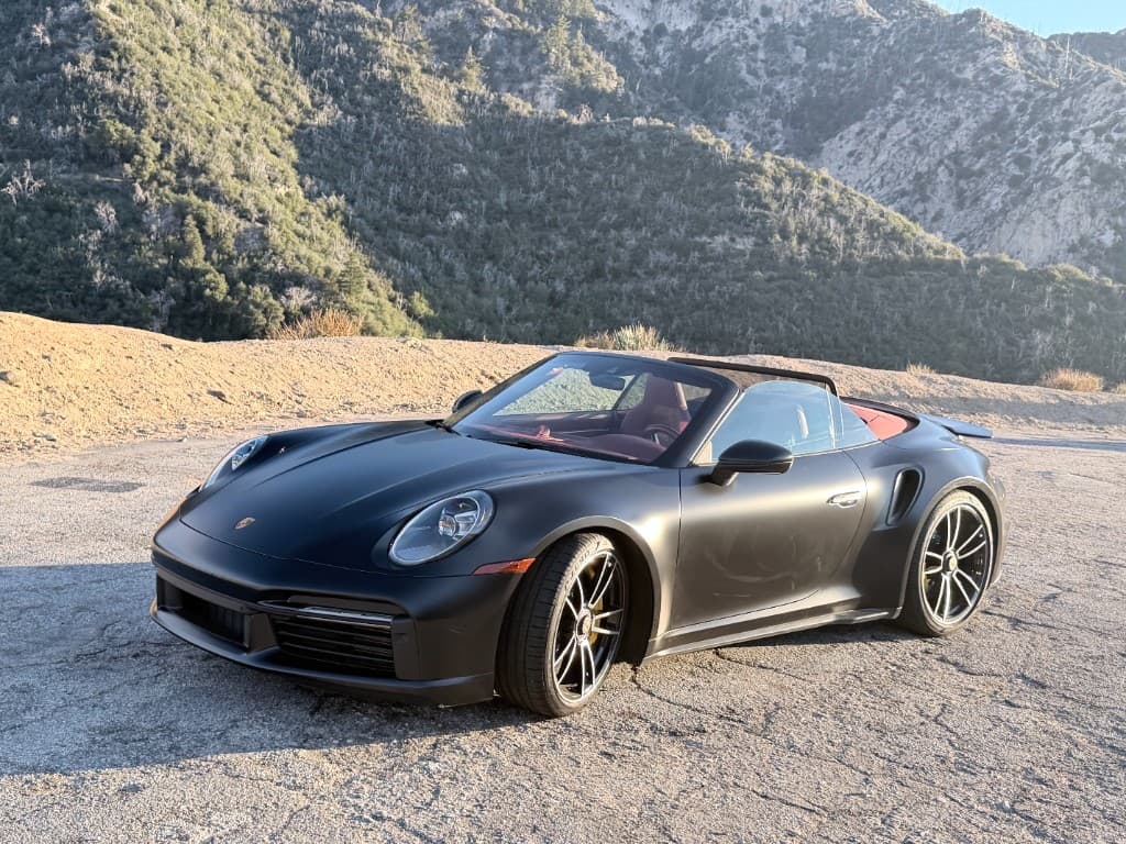 Porsche 911 Turbo S Cabriolet — wide side profile at a scenic overlook