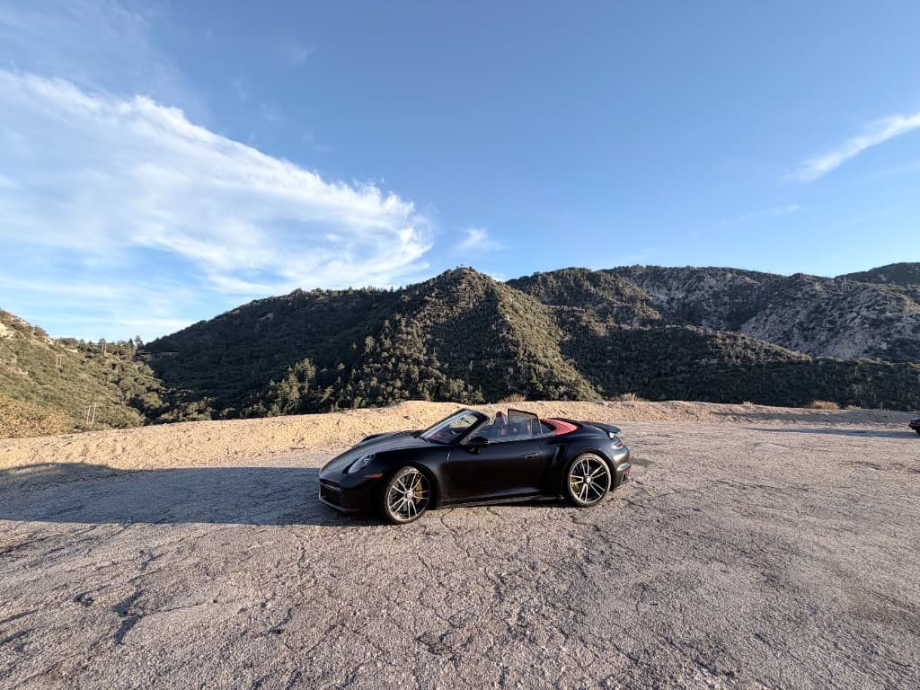 Porsche 911 Turbo S Cabriolet — side profile with mountain backdrop