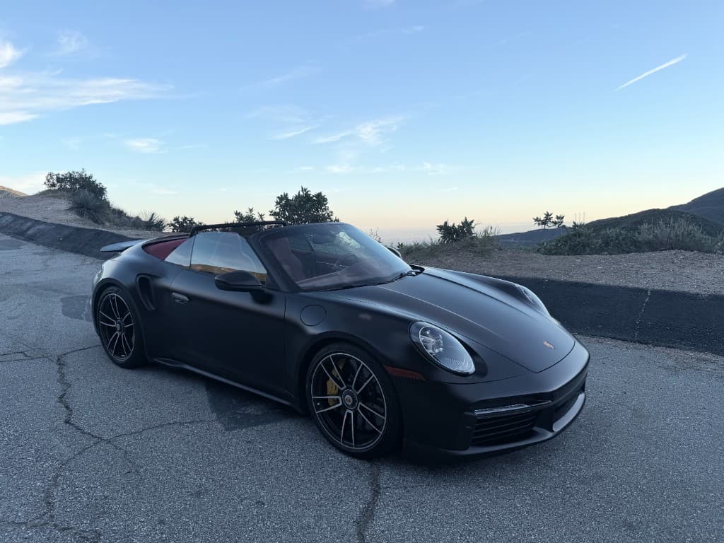 2022 Porsche 911 Turbo S Cabriolet — front three-quarter on a mountain road