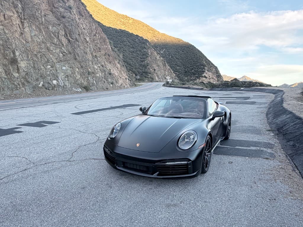 Porsche 911 Turbo S Cabriolet — front three-quarter on a gravel turnout