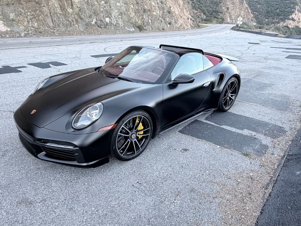 Porsche 911 Turbo S Cabriolet — front angle on a mountain road