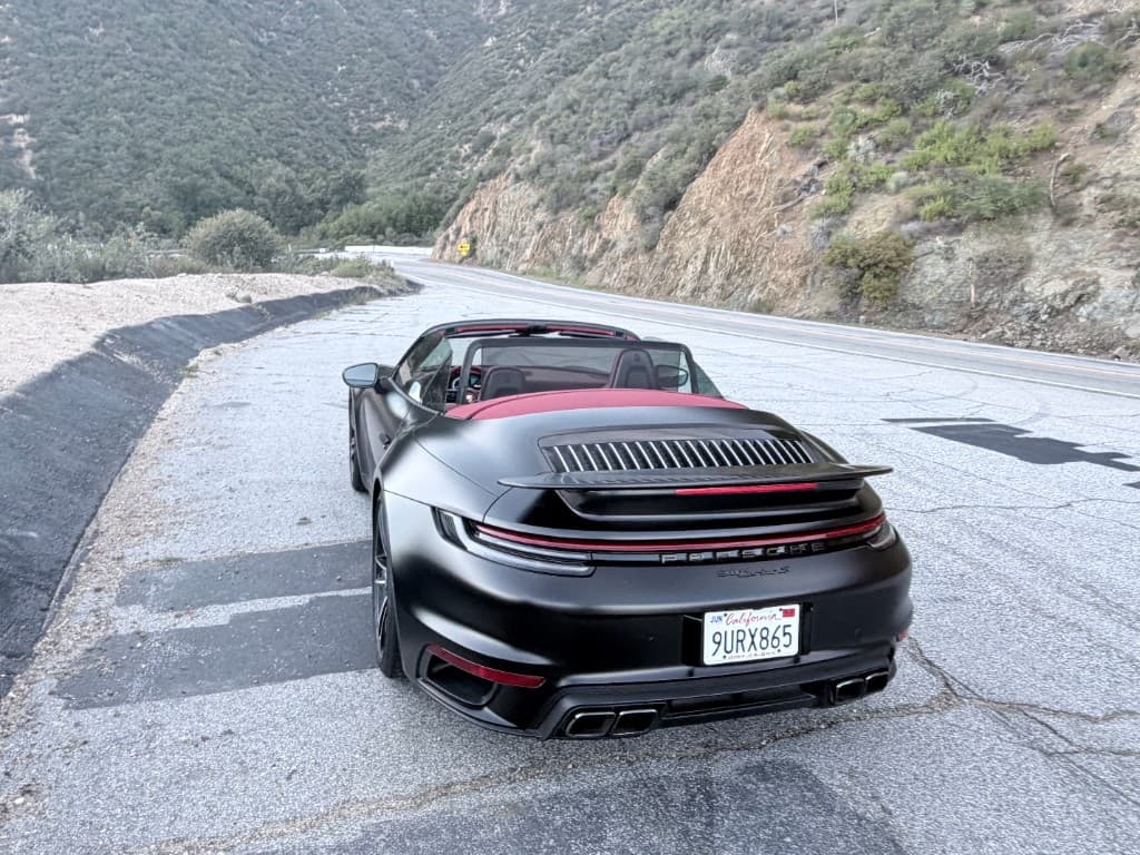 Porsche 911 Turbo S Cabriolet — front three-quarter at a roadside pull-off