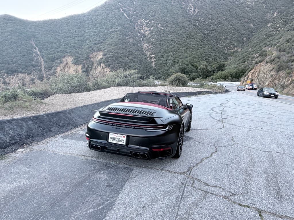 Porsche 911 Turbo S Cabriolet — rear three-quarter with top down