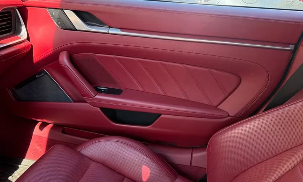 Porsche 911 Turbo S Cabriolet — passenger door panel with quilted leather and Burmester audio