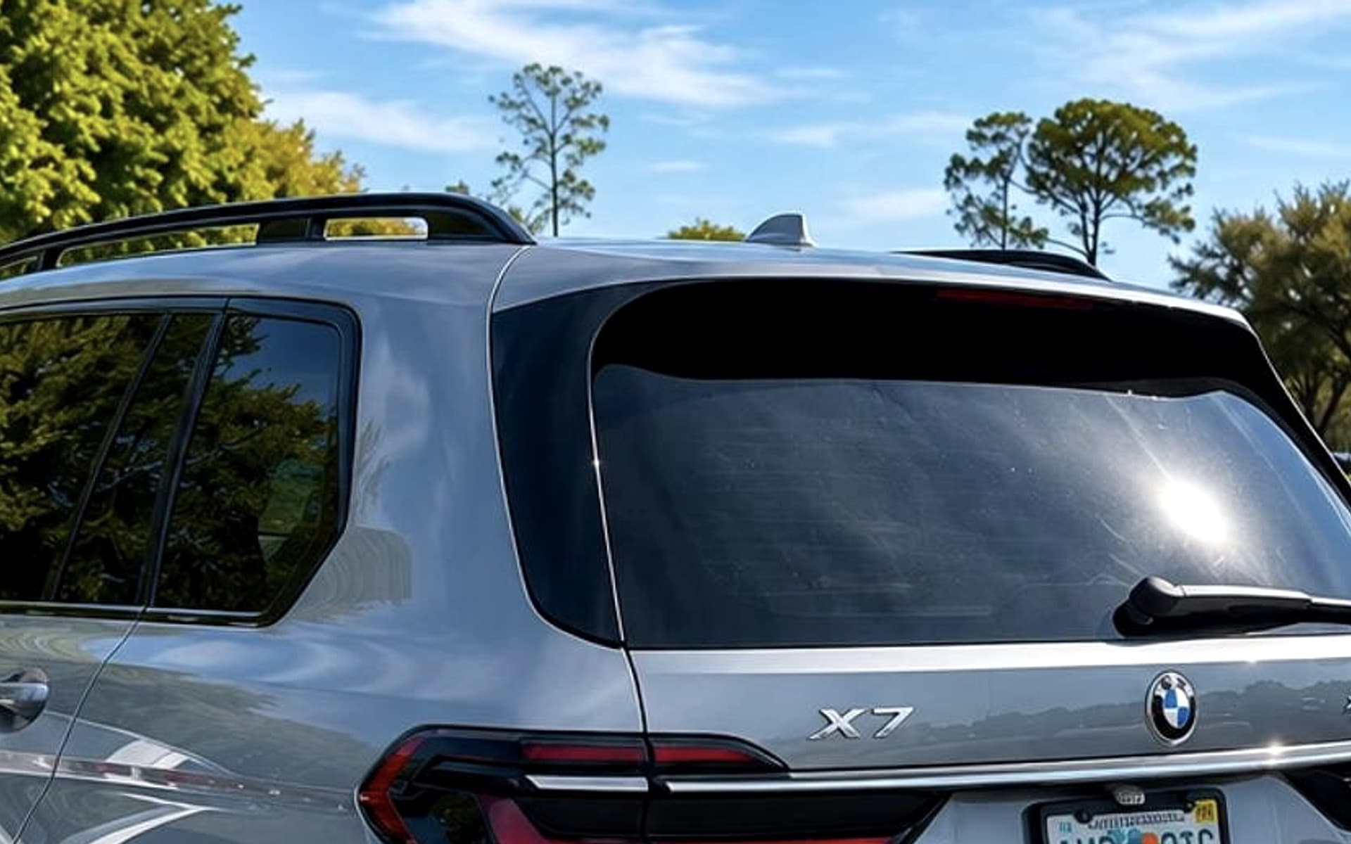 2023 BMW X7 xDrive40i — rear three-quarter profile in natural light